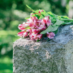 tombstone with flowers on top